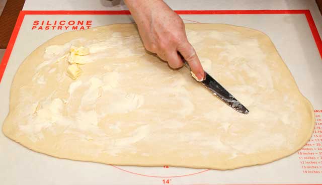Spread butter over dough