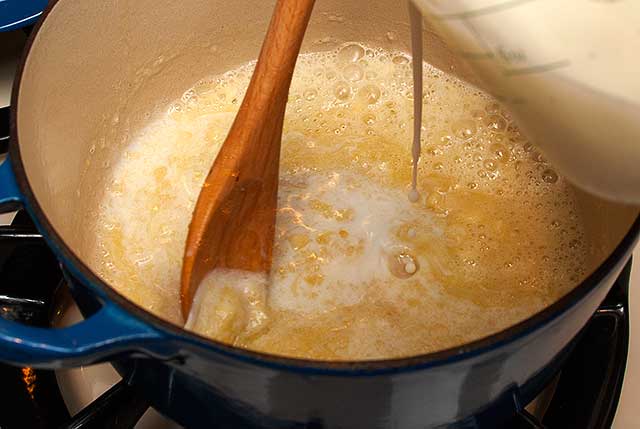 Adding milk to the cheese sauce