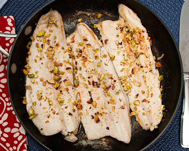 fish with brown butter sauce and chopped pistachios